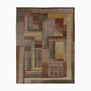 Alfombra en beige y marrón con motivos geométricos de Rug & Kilim