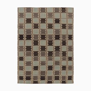 Alfombra con motivos geométricos en beige, marrón y azul de Rug & Kilim