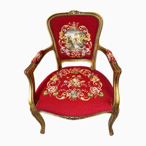 Poltrona in stile Luigi XVI con struttura in legno dorato