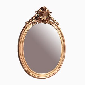 Espejo antiguo oval con marco de madera dorada