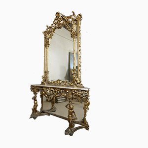 Consola antigua de madera dorada con espejo