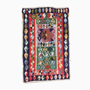 Tappeto Tribal Kilim vintage piccolo in lana nera, rossa, blu e verde, Turchia, anni '50