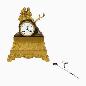 Reloj de chimenea francés de bronce bañado en oro, década de 1820