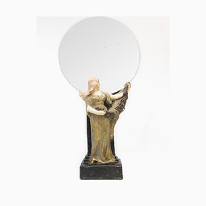 Espejo modernista con estatua de mujer