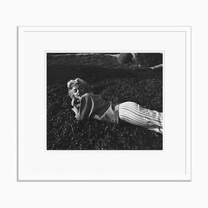 Stampa Marilyn Monroe Relaxing on the Grass in resina argentata con cornice bianca di Baron