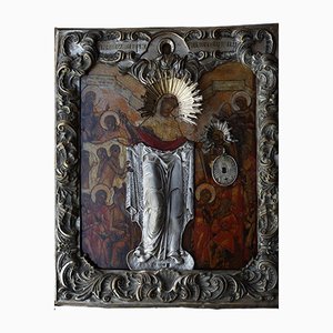 Icono antiguo de la Madre de Dios, gozo de todos los que afligen, en un marco barroco de plata