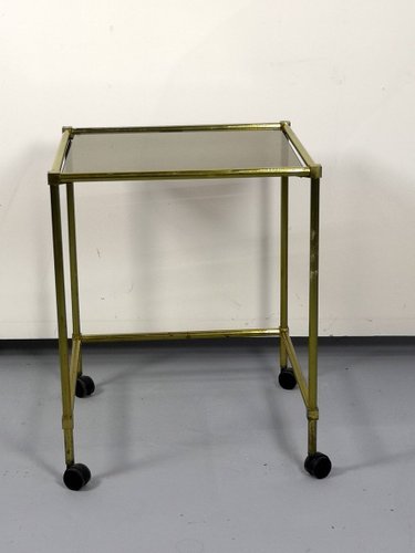 Vintage Brass Side Table On Wheels With Smoked Glass Top For Sale At Pamono The side tables with wheels available on the site are made of different materials such as wood, aluminum, marble, steel, glass and so on, so that you can pick the best one to go with your these side tables with wheels are offered in various shapes and sizes ranging from trendy to classic ones. vintage brass side table on wheels with smoked glass top