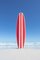 John White, Red and White Striped Retro Surfboard mit dem Ozean im Hintergrund, Fotopapier 1