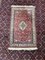Handgestrickter orientalischer Teppich mit Tier- und Blumenmotiven 1