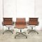 Cognacfarbene EA107 Bürostühle aus Leder & Aluminium von Charles & Ray Eames für Vitra, 1990er, 8er Set 2