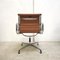 Cognacfarbene EA107 Bürostühle aus Leder & Aluminium von Charles & Ray Eames für Vitra, 1990er, 8er Set 5