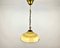 Lámpara colgante de vidrio amarillo con detalles de latón, años 60, Imagen 1