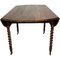 Großer antiker ausziehbarer französischer provenzalischer Tisch aus Nussholz mit gedrechselten Beinen und Messingrädern 3