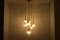 Kaskadenlampe aus Messing mit Bernsteinfarbenen Kugelschirmen, 1950er 3