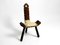 Taburete Mid-Century de tres patas con respaldo de madera con asiento de cuero de vaca en negro y marrón, años 50, Imagen 2