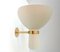 Cream colored metal and brass diabolo shaped wall lamp, 1960s 1
