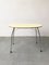 Mid-Century Yellow Formica and Polished Steel Coffee Table with Folding Legs, 1950s, Image 1