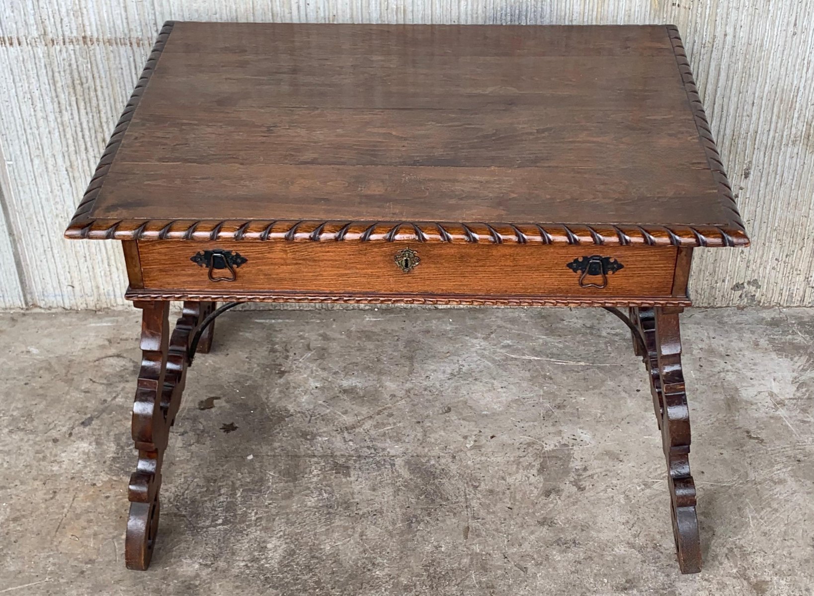 Early 20thCentury Spanish Desk with Lyre Legs and Carved Edges on Top