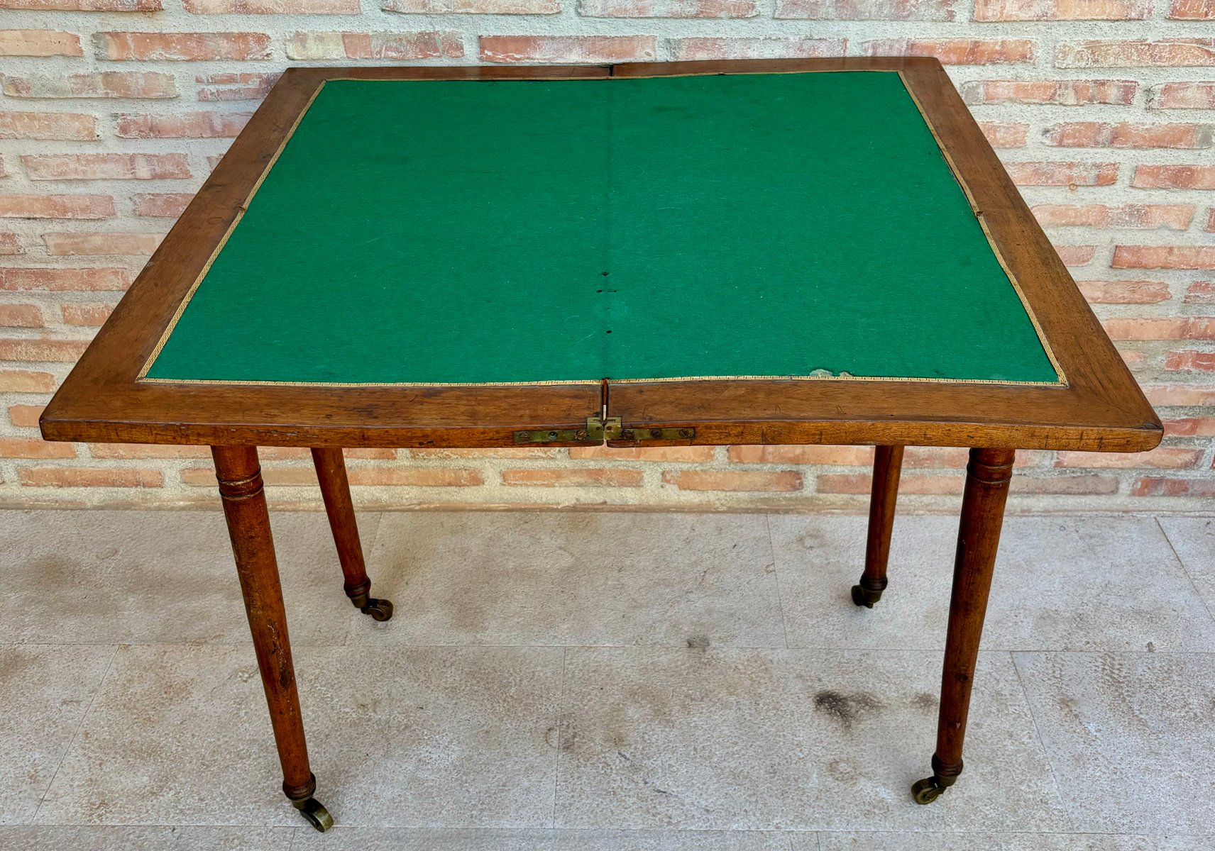 Early 20th century french walnut game table with wheels 1920s for sale